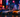 Iconic Tokoyo Drift cars lined up with vibrant city lights in the background.