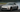 Nissan 350Z with upgraded SLR angle kit mid-drift showing extreme steering angle on a track