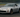 Nissan 350Z with upgraded SLR angle kit mid-drift showing extreme steering angle on a track