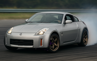 Nissan 350Z with upgraded SLR angle kit mid-drift showing extreme steering angle on a track