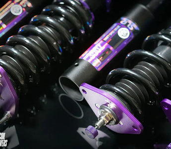 Close up of 350z coilovers and camber plates with holographic labels