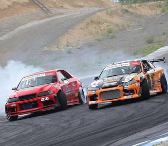 Lineup of best drift cars at a racetrack including BMW E36, Nissan 350Z, and S13