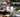 A collection of Assetto Corsa cars racing on a virtual track