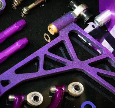 SLR 350Z angle kit components laid out on a shop bench with control arms, knuckles, and tie rods visible