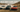 A 370Z, E36, and RX7 FD drifting side by side in Arizona