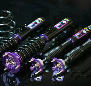 Coilovers for E46 laying on table full kit