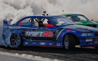Adam LZ's E36 drift car smoking out the car behind him in Formula Drift