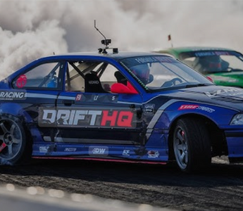 Adam LZ's E36 drift car smoking out the car behind him in Formula Drift
