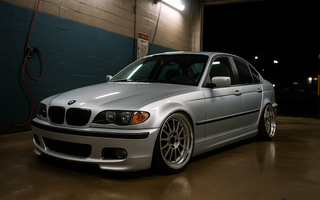 Lowered BMW E46 on coilovers at a night car wash, featuring aggressive stance, deep wheels, and performance suspension setup.