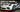 A Porsche 911 race car on SLR ramps for changing oil