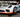 A Porsche 911 race car on SLR ramps for changing oil