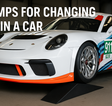 A Porsche 911 race car on SLR ramps for changing oil