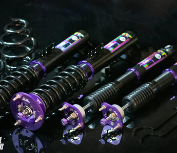 E36 coilover installed on front strut with adjustment knob visible