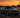 Slammed BMW E46 M3 with aggressive fitment sitting in a Florida car show parking lot at sunset, featuring SLRspeed E46 coilovers and palm trees in the background.