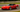 A C5 Corvette on coilovers and custom angle kit driving on a race track, showcasing aggressive stance and handling