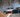 Three drift cars on a mountain pass drifting with different styles and techniques