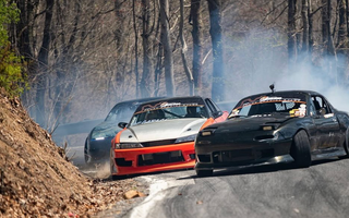 Three drift cars on a mountain pass drifting with different styles and techniques