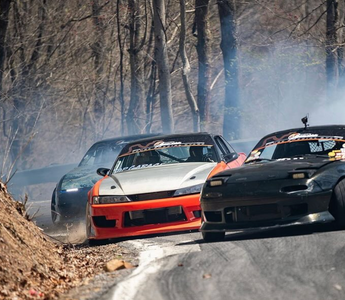 Three drift cars on a mountain pass drifting with different styles and techniques