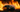 A professional car drifting through a fire lit track in Florida competition