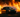 A professional car drifting through a fire lit track in Florida competition