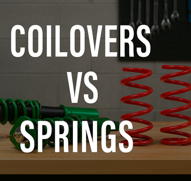Comparison of coilovers and lowering springs side by side on a garage workbench