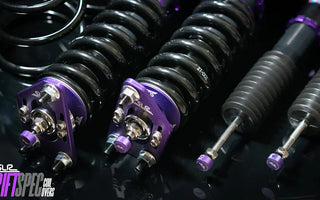 A set of coilovers on the table next to a set of springs