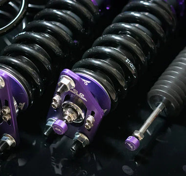 A set of coilovers on the table next to a set of springs