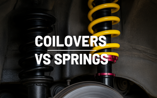 A picture of springs and coilovers side by side in wheel well of car