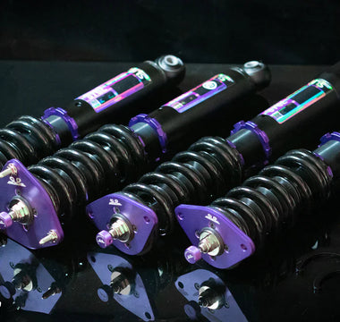 Coilover suspension installed on modified car showing spring and damper as one adjustable unit.