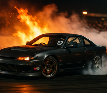 Showing drifting meaning a car drifting on a track controlled sideways