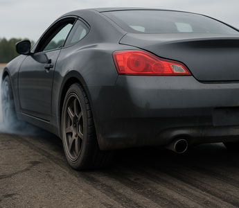 Drift car rear view with worn tires and suspension components visible after a drift session