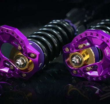 purple anodized E30 camber plates close-up