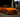 Orange widebody BMW E36 M3 slammed at a gas station pump at night with the front wheels turned, showcasing aggressive stance, drift fitment, and performance styling with E36 angle kit.