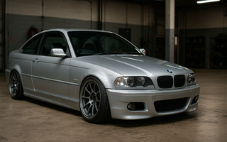 BMW E46 lowered on performance coilovers parked in a garage, highlighting aggressive camber, low ride height, and upgraded suspension geometry.