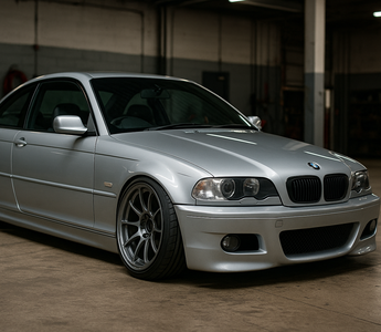 BMW E46 lowered on performance coilovers parked in a garage, highlighting aggressive camber, low ride height, and upgraded suspension geometry.