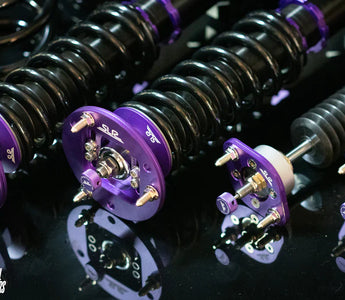close up of E46 coilovers on a dark table laid out