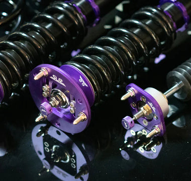 close up of E46 coilovers on a dark table laid out