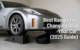 Black low-profile car ramps holding up a sports car during an oil change