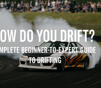 A drift car mid-slide with smoke, countersteer, and crowd in background at a drift track
