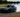 Car mid-drift on a closed track, tires smoking, showing perfect countersteer control