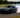 Car mid-drift on a closed track, tires smoking, showing perfect countersteer control