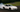 sports car mid-drift on a racetrack