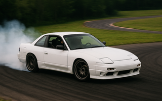sports car mid-drift on a racetrack