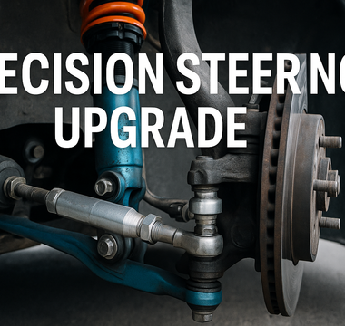 Close-up of a performance inner tie rod installed on a car steering rack with upgraded control arms