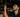 A mechanic looking at a inner tire rod on a car which is on a lift