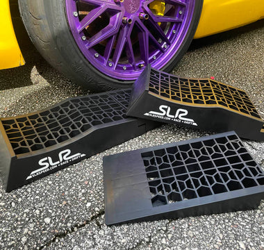 low profile car ramps next to a race car ready to do an oil change and change suspension settings