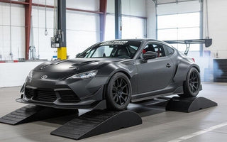 garage setup with car on low ramps