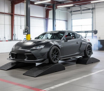 garage setup with car on low ramps