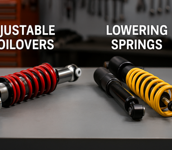 Close-up of adjustable coilovers and lowering springs side by side, mounted on a garage bench for comparison.