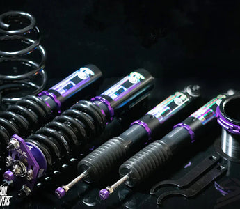 Side-by-side comparison of a car with lowering springs and another with coilovers, showing differences in ride height and stance.